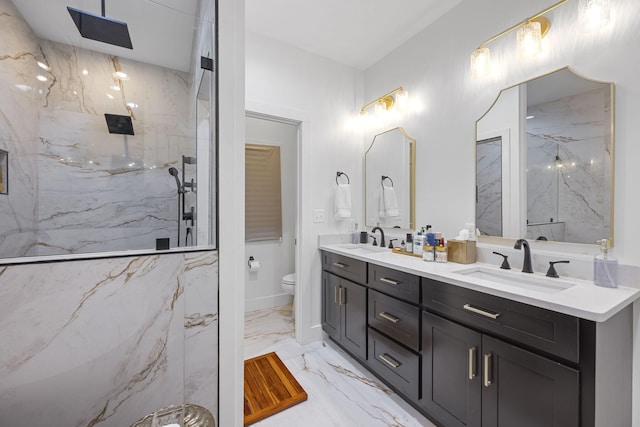 bathroom featuring vanity, toilet, and a tile shower