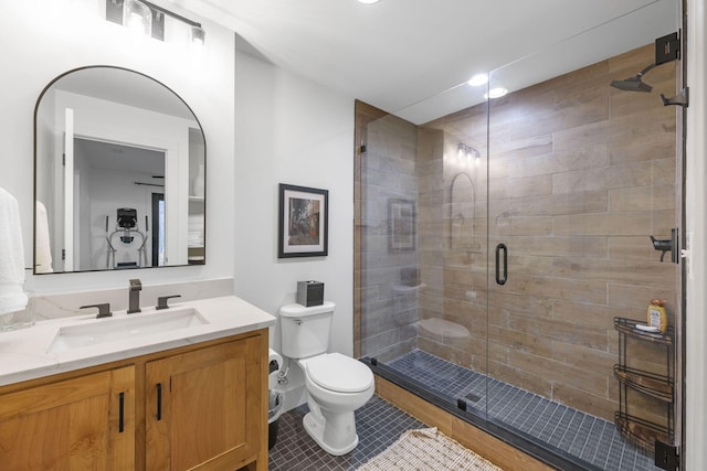 bathroom with vanity, tile patterned flooring, toilet, and walk in shower