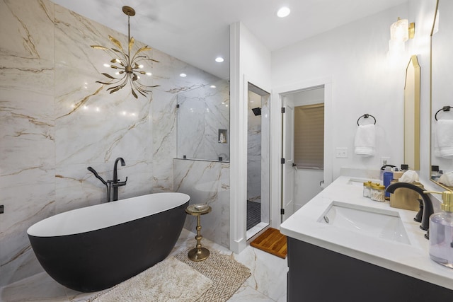 bathroom featuring vanity, tile walls, and separate shower and tub