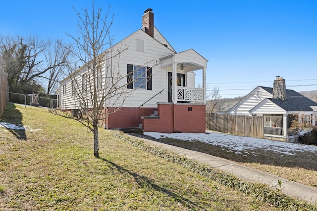 view of side of property with a yard