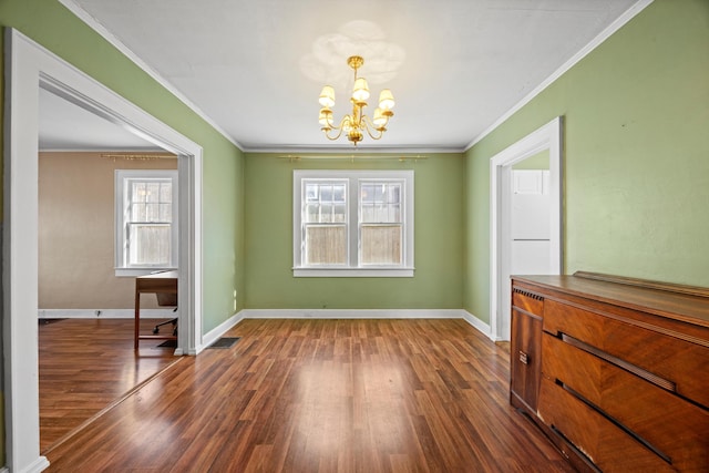 dining area featuring dark hardwood / wood-style flooring, a wealth of natural light, a chandelier, and ornamental molding