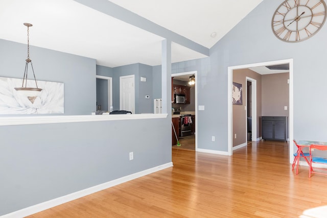 unfurnished living room with vaulted ceiling, ceiling fan, and hardwood / wood-style floors