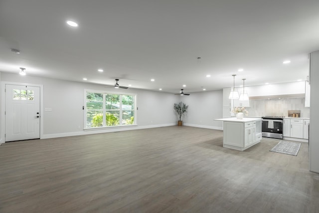 kitchen with pendant lighting, a kitchen island, white cabinetry, ceiling fan, and stainless steel electric range