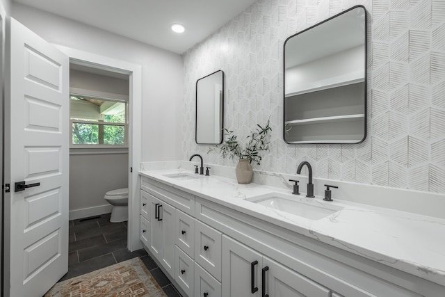 bathroom featuring toilet and vanity