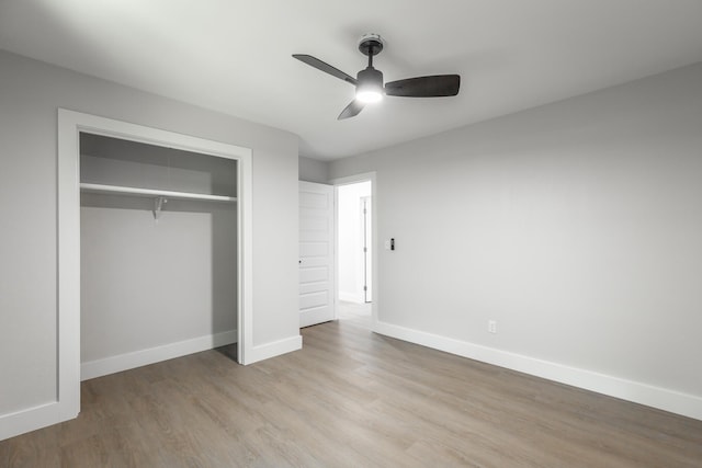 unfurnished bedroom with ceiling fan, a closet, and light hardwood / wood-style flooring