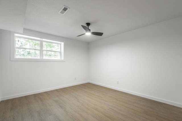 empty room featuring ceiling fan and hardwood / wood-style floors