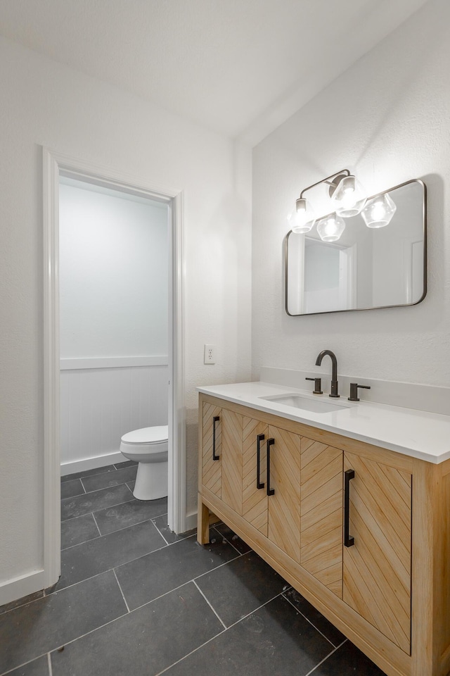 bathroom featuring toilet and vanity