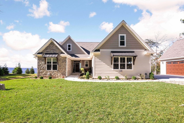 craftsman-style house featuring a garage and a front lawn