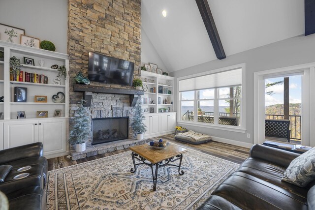 3745 Raulston Falls Rd, Jasper, TN 37347 - living room featuring wood-type flooring, a stone fireplace, high vaulted ceiling, and beam ceiling