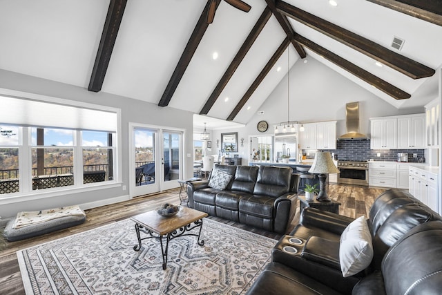 3745 Raulston Falls Rd, Jasper, TN 37347 - living room featuring wood-type flooring, beam ceiling, high vaulted ceiling, and a wealth of natural light