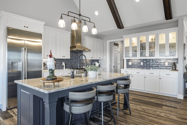 3745 Raulston Falls Rd, Jasper, TN 37347 - kitchen with white cabinetry, light stone counters, hanging light fixtures, stainless steel built in fridge, and an island with sink