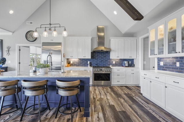 3745 Raulston Falls Rd, Jasper, TN 37347 - kitchen featuring high quality appliances, a kitchen island with sink, wall chimney range hood, and white cabinets