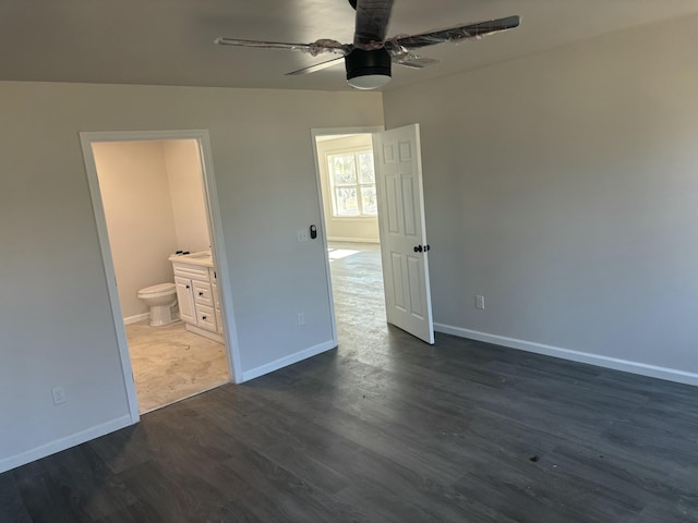 unfurnished bedroom featuring dark wood-type flooring, ceiling fan, and ensuite bathroom