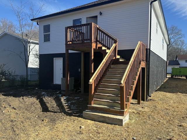 back of property featuring a deck and central AC