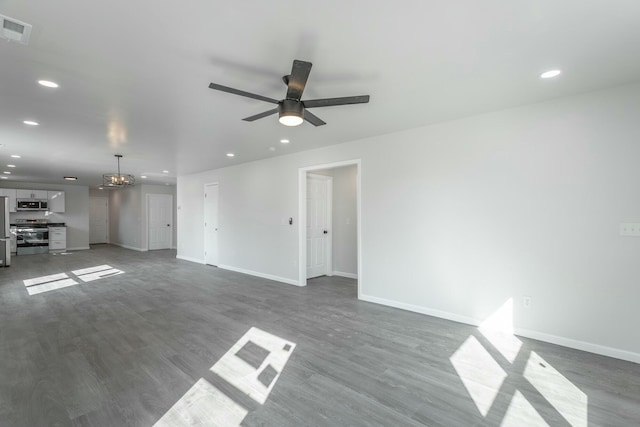 unfurnished living room with ceiling fan and dark hardwood / wood-style floors