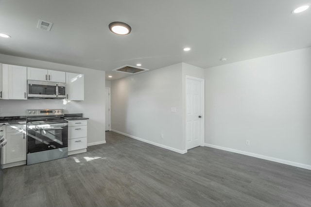 kitchen featuring dark wood-type flooring, stainless steel appliances, and white cabinets