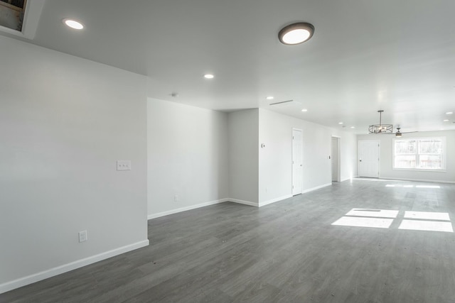 empty room with ceiling fan and dark hardwood / wood-style floors