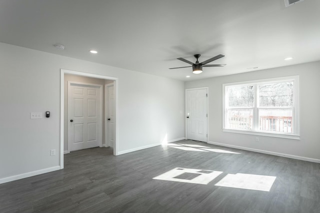 spare room with ceiling fan and dark hardwood / wood-style floors