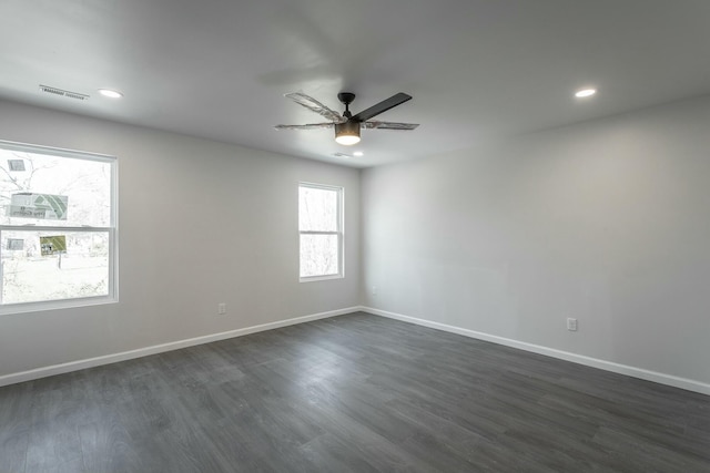 unfurnished room featuring ceiling fan and dark hardwood / wood-style flooring