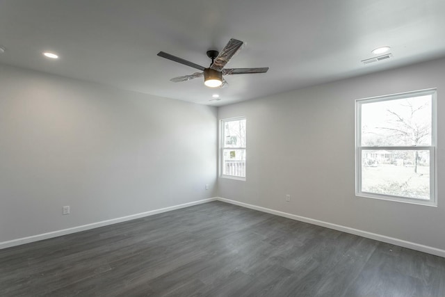 spare room with ceiling fan and dark hardwood / wood-style flooring