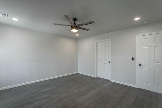 empty room featuring ceiling fan and dark hardwood / wood-style floors