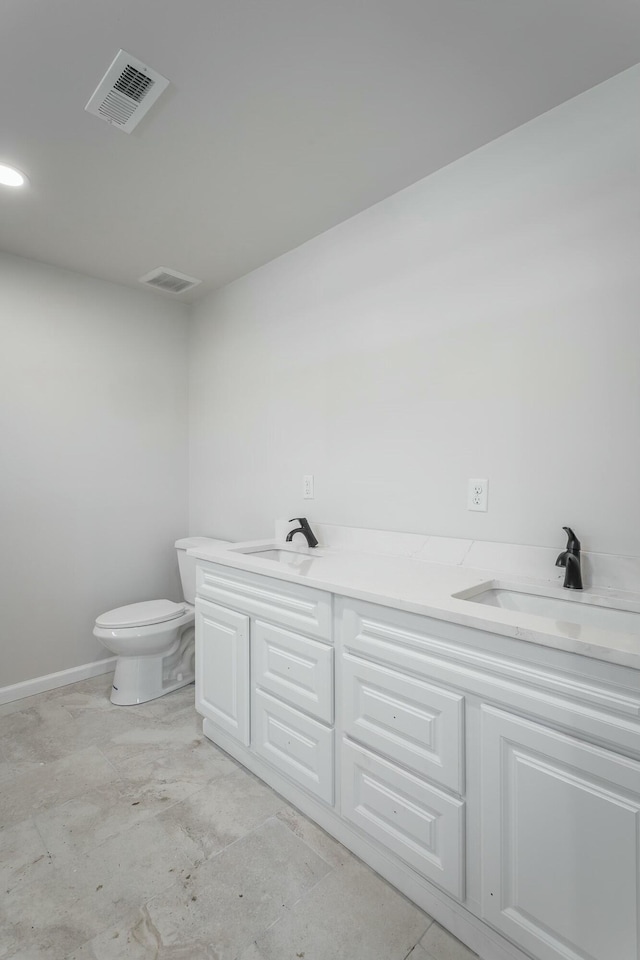 bathroom with toilet and vanity