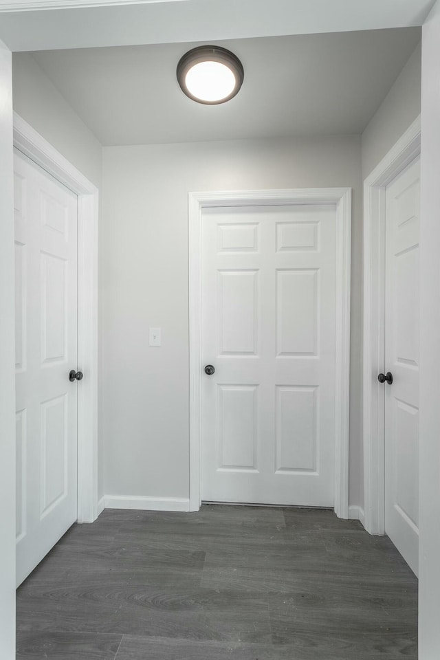 corridor featuring dark wood-type flooring