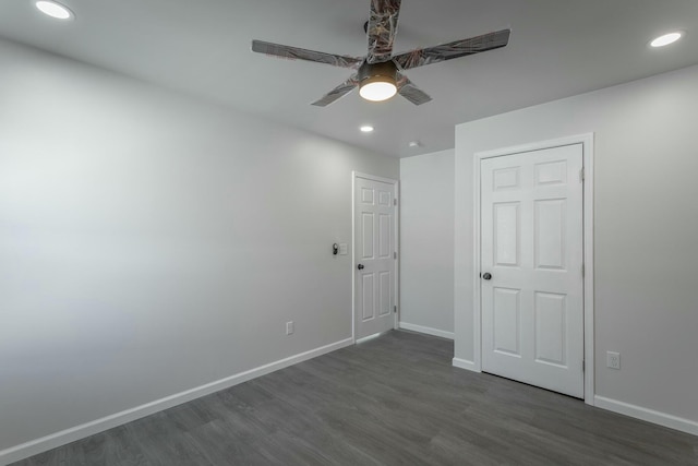 unfurnished bedroom featuring ceiling fan and dark wood-type flooring