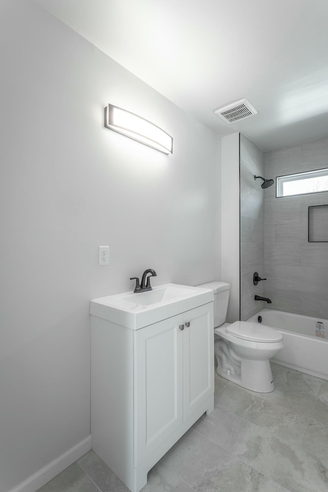 full bathroom with toilet, vanity, and tiled shower / bath combo