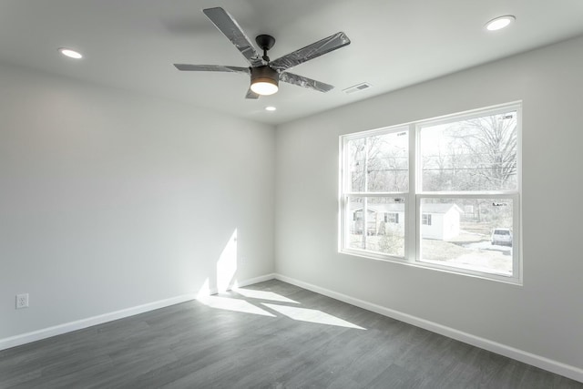 unfurnished room with ceiling fan and dark hardwood / wood-style floors