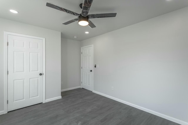 unfurnished bedroom with ceiling fan, dark hardwood / wood-style flooring, and a closet