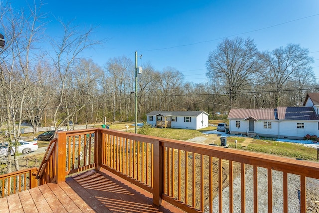 wooden deck featuring a lawn