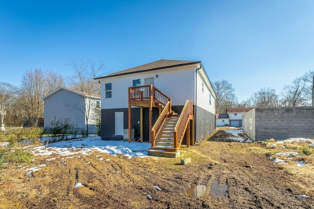 back of house featuring a wooden deck