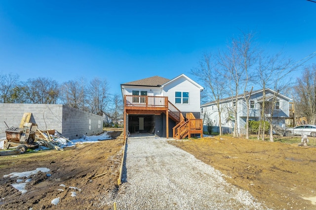 view of front of home with a deck and a carport