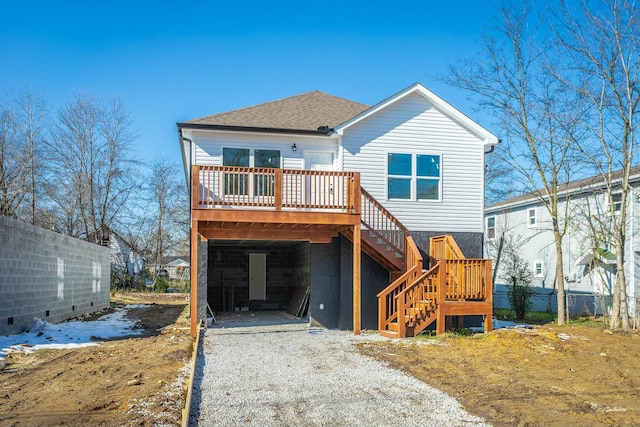 rear view of property featuring a wooden deck