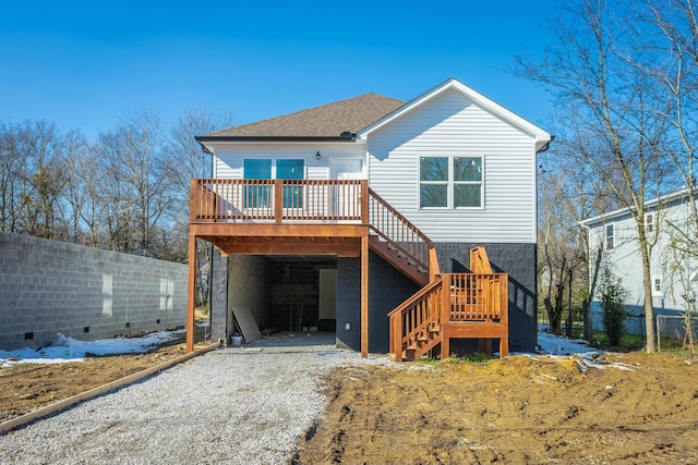 back of house featuring a deck and a carport