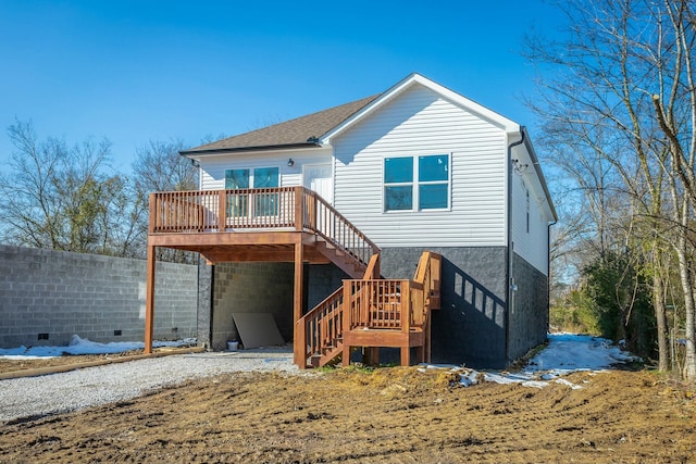 back of property featuring a wooden deck