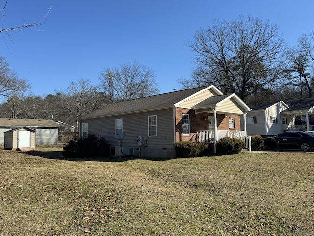 view of front of house with a storage unit and a front yard