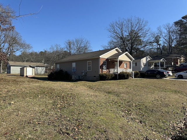 view of front of property with a front yard, a porch, and a shed