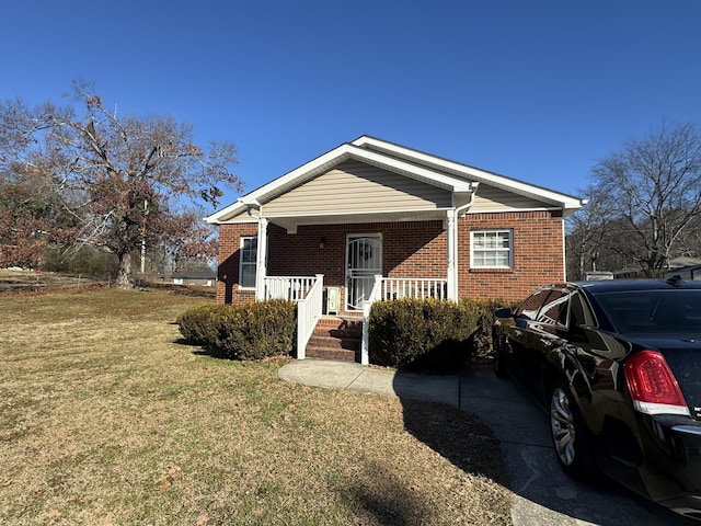 view of front facade with a front yard and a porch