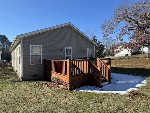 back of house with a lawn and a wooden deck