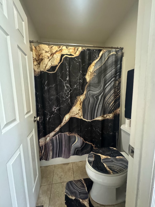 bathroom with toilet and tile patterned floors