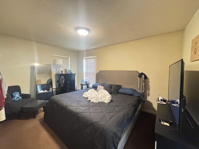 bedroom with carpet and a textured ceiling