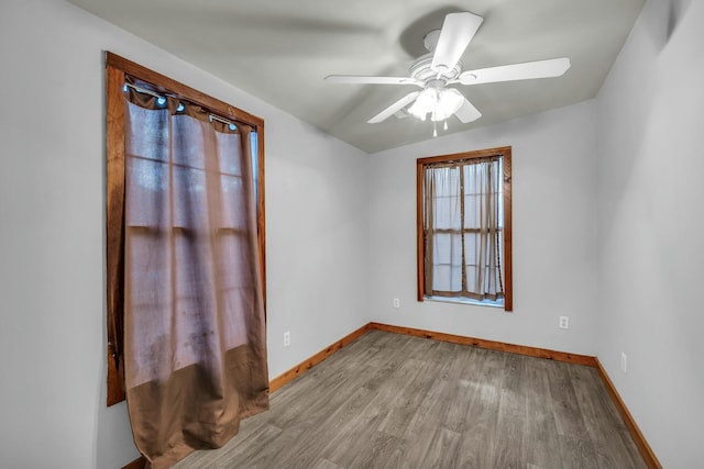 unfurnished room with light wood-type flooring and ceiling fan