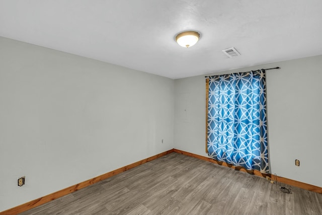 unfurnished room featuring hardwood / wood-style floors