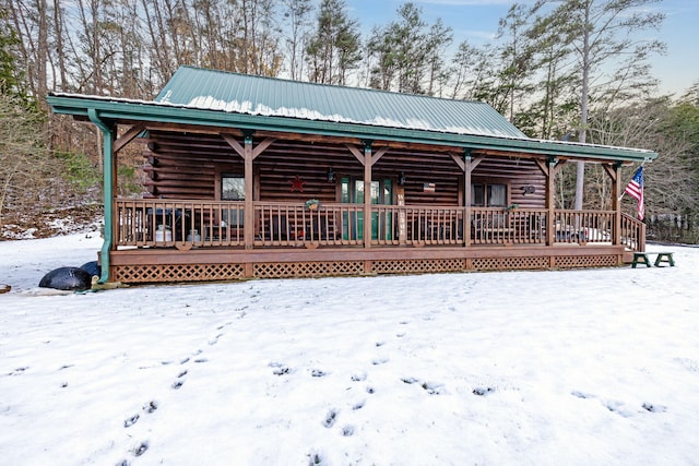 view of snow covered back of property