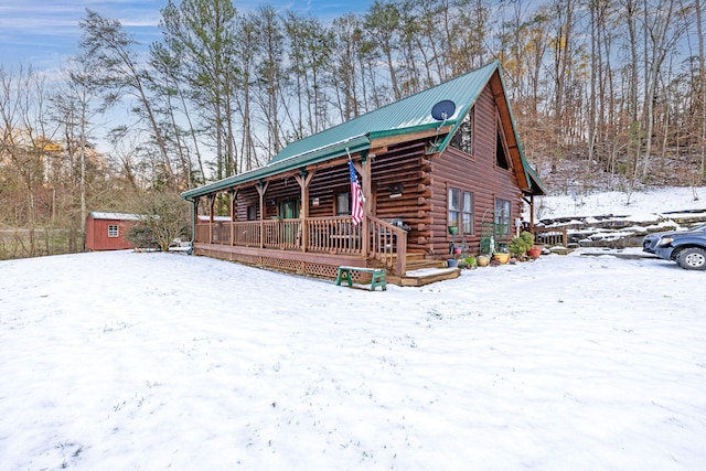 view of front facade with a shed and covered porch