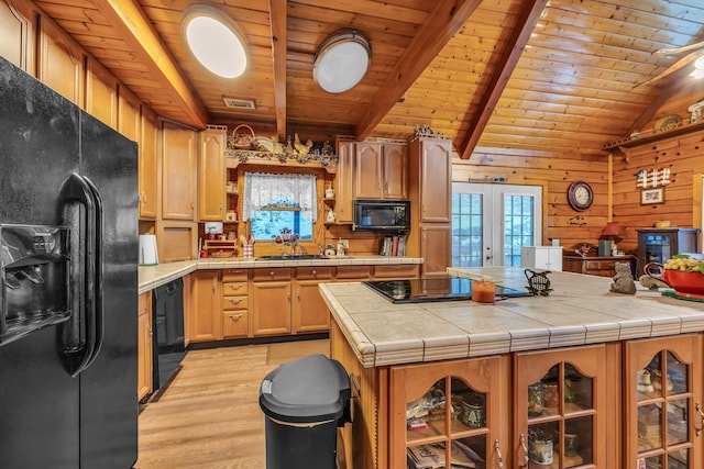 kitchen with black appliances, french doors, wood ceiling, and tile countertops