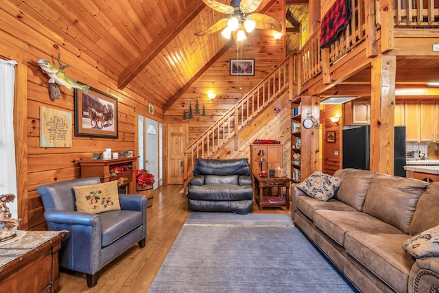 living room with beam ceiling, wood-type flooring, wooden ceiling, and high vaulted ceiling