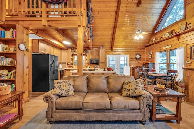 living room featuring wood ceiling, wood walls, ceiling fan, beam ceiling, and light hardwood / wood-style flooring